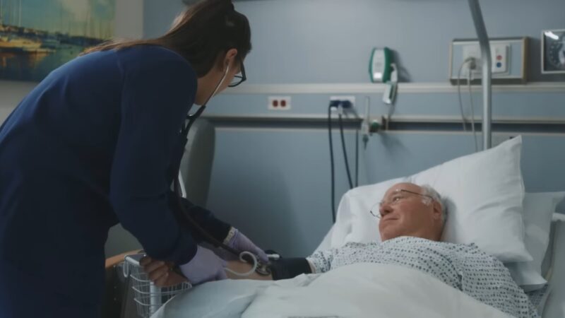 A Nurse Taking a Patient's Blood Pressure in A Hospital Bed, Representing the Implementation of Evidence-Based Practice in Nursing Care