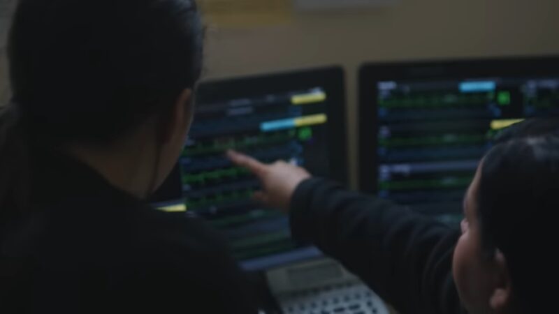 Two Nurses Collaborating While Analyzing Patient Data on Monitors, Highlighting the Importance of Leadership and Teamwork Skills in Nursing