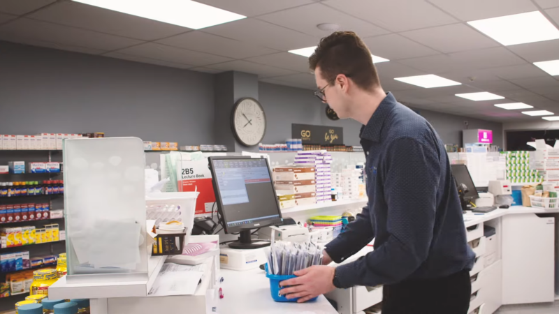 A Pharmacist Organizing Supplies at The Counter, Demonstrating Flexibility in Managing Daily Tasks