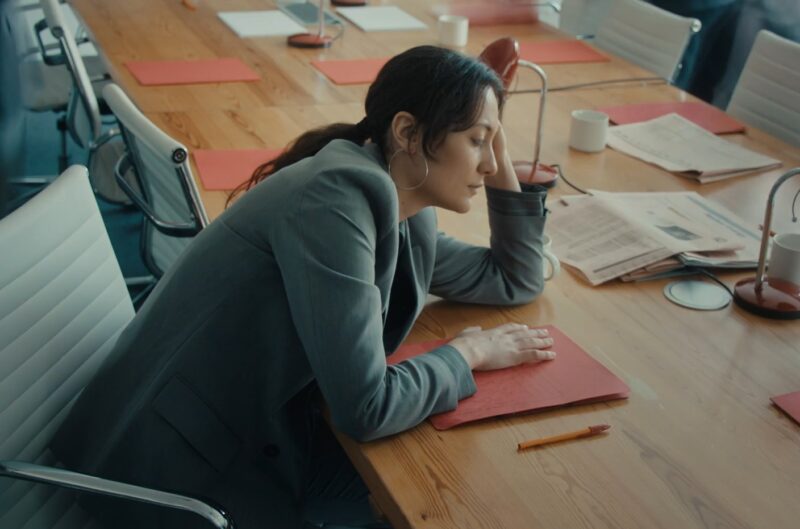 Woman sitting at the work table, struggling to stay away