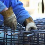 A Construction Worker Reinforcing Steel Bars, Highlighting the Risks Associated with Dangerous Jobs in The Industry