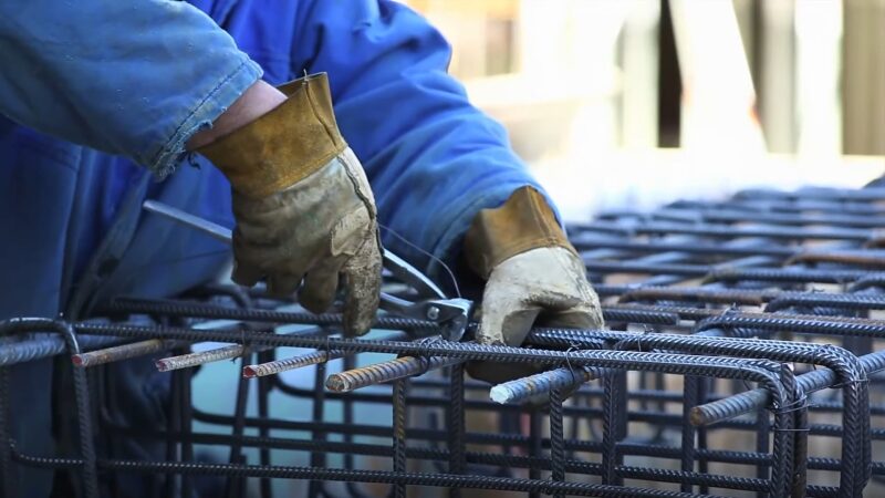 A Construction Worker Reinforcing Steel Bars, Highlighting the Risks Associated with Dangerous Jobs in The Industry